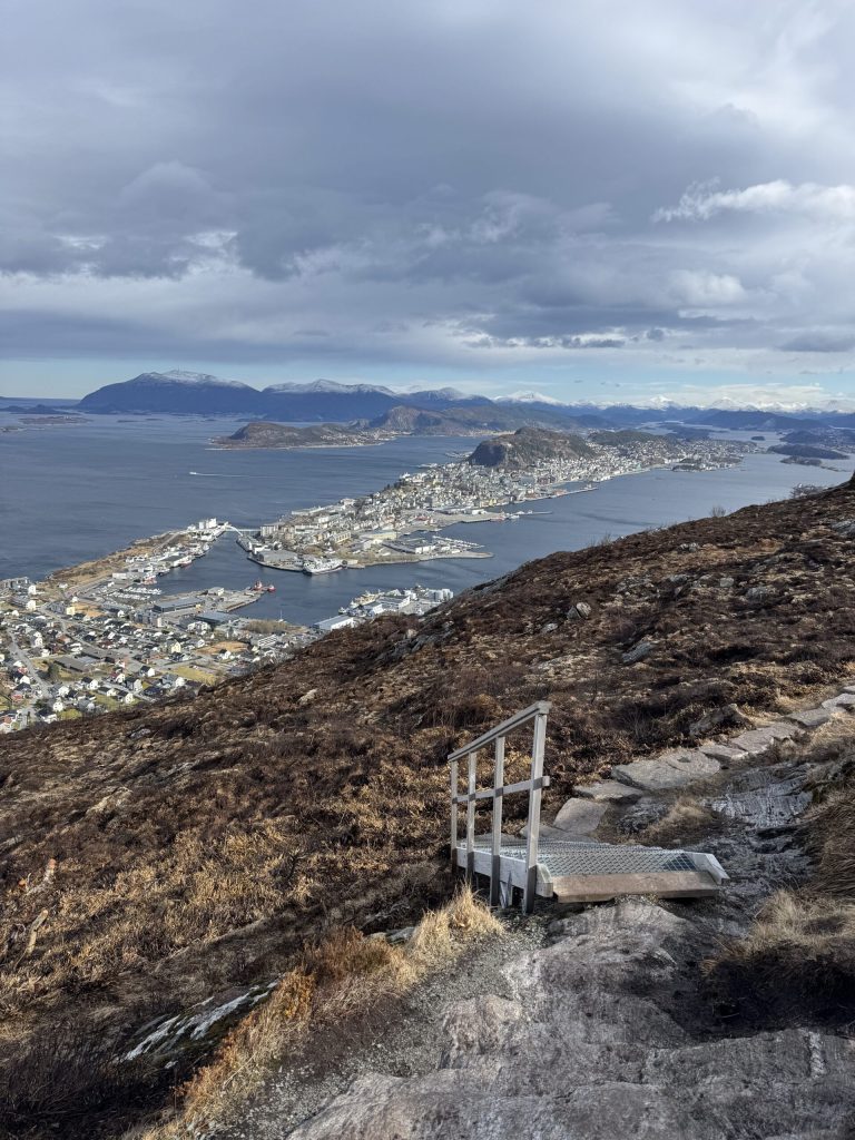 Escalones del sendero de Sukkertoppen con Ålesund al fondo